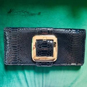 Michael Kors black and gold clutch bag.